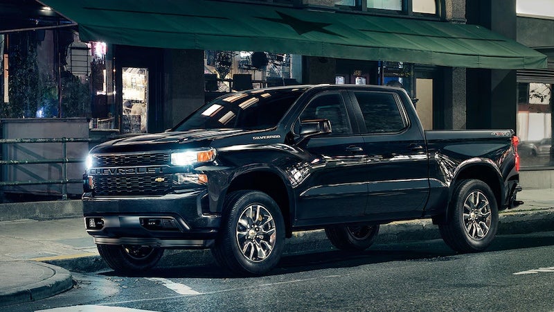 Black Silverado parked next to the road